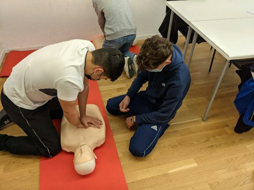  CPR on a training manikin in a classroom 